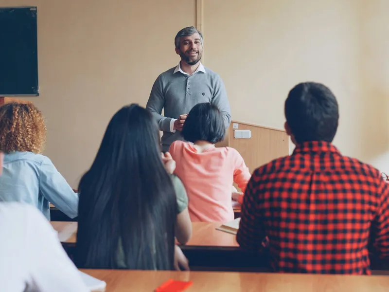 A teacher lecturing students in a classroom